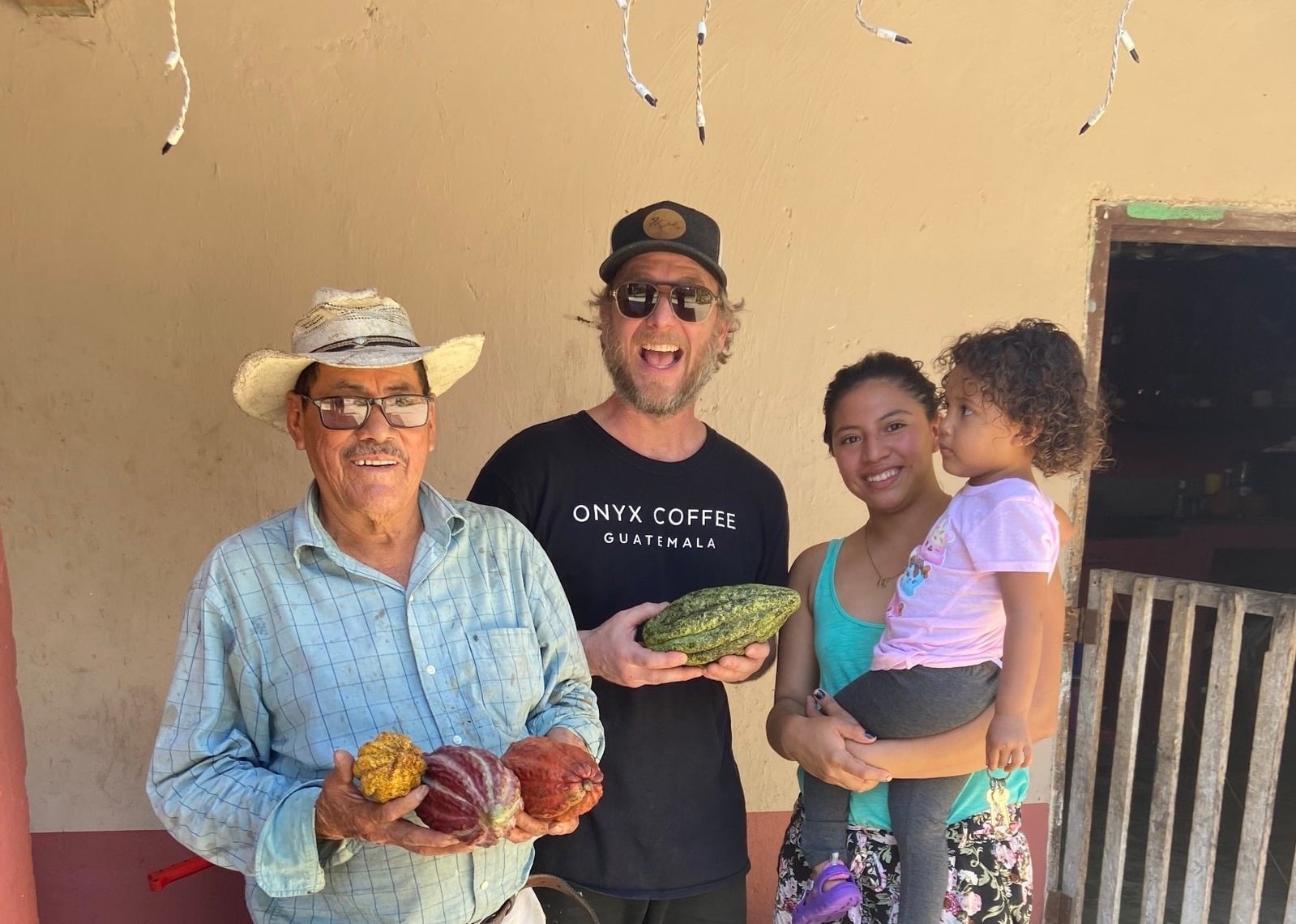 Cacao producers working with a small-batch fermentation box